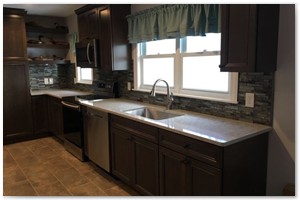 Shaker style cabinets with granite counter tops and a center island. New Hampshire renovation.