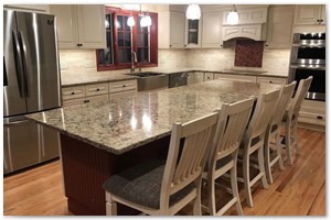 Shaker style cabinets with granite counter tops and a sit down island. New Hampshire remodel.
