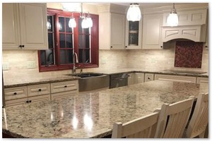 Shaker style cabinets with granite counter tops and a sit down island. New Hampshire renovation.