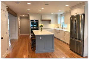 Shaker style cabinets with Corian counter tops and a sit down island. New Hampshire remodel.